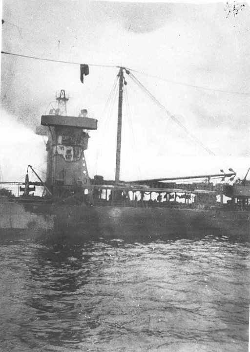 kanawha-photo9.jpg - USS Kanawha (AO-1) on fire at Tulagi Harbor, Solomon Islands, 7 April 1943 after being attacked by Japanese aircraft.